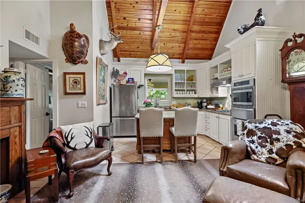 a living room with furniture and a kitchen