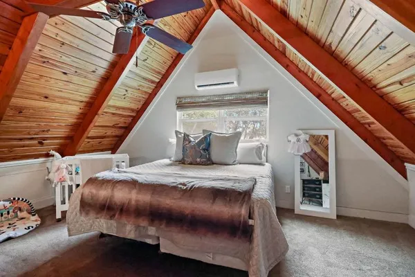 a bed sitting in a bedroom next to a window