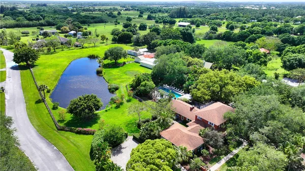 an aerial view of a house with yard and outdoor seating