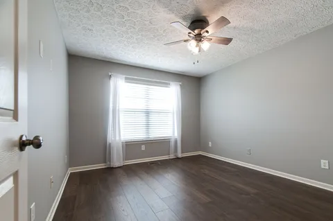 a bathroom with a granite countertop sink toilet a mirror and shower