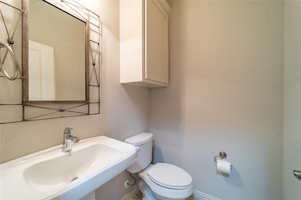 4666 Rhett Lane, Unit E Carrollton, TX 75010 - Photo 14 of 40 Tall cabinets in the half bath