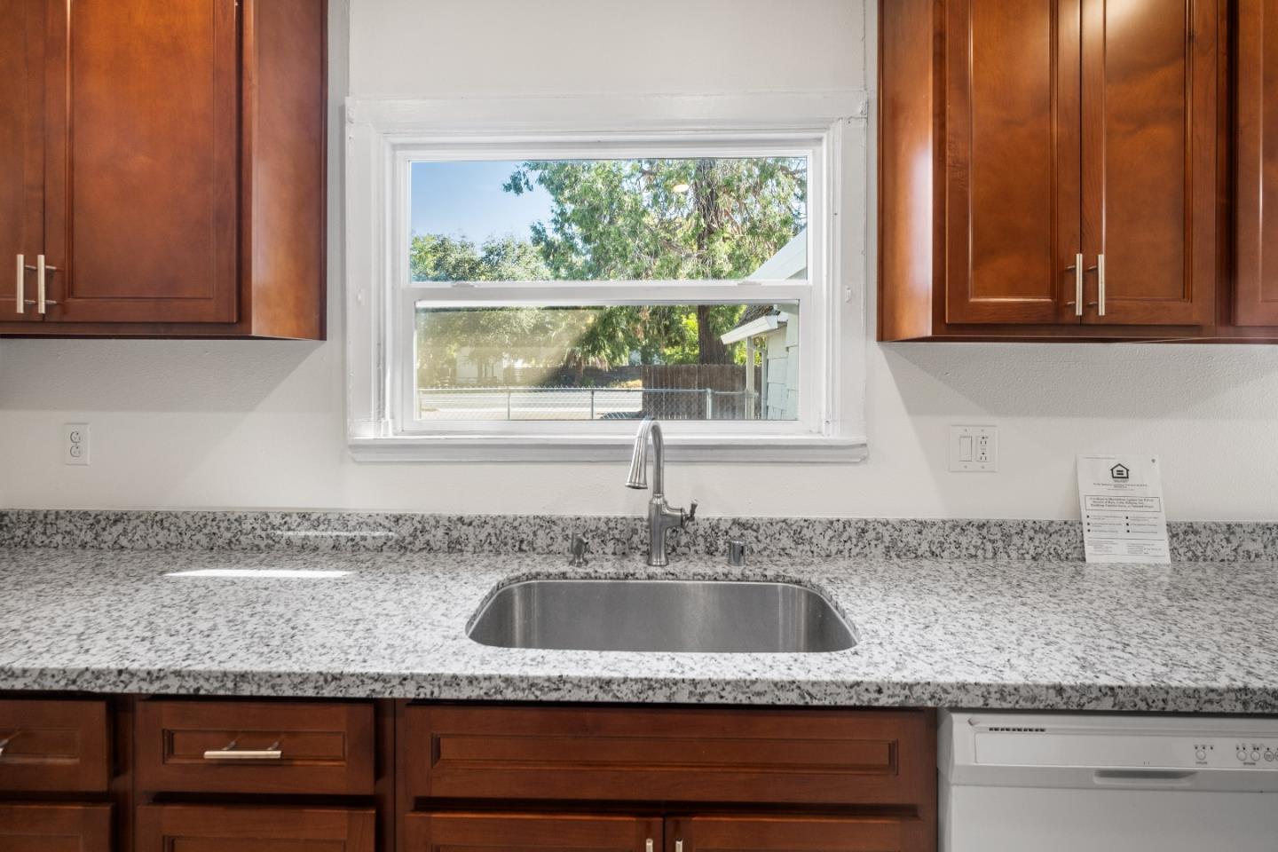 2905 Garfield Avenue Carmichael, CA 95608 - Photo 18 of 32 a kitchen with granite countertop a sink and a window