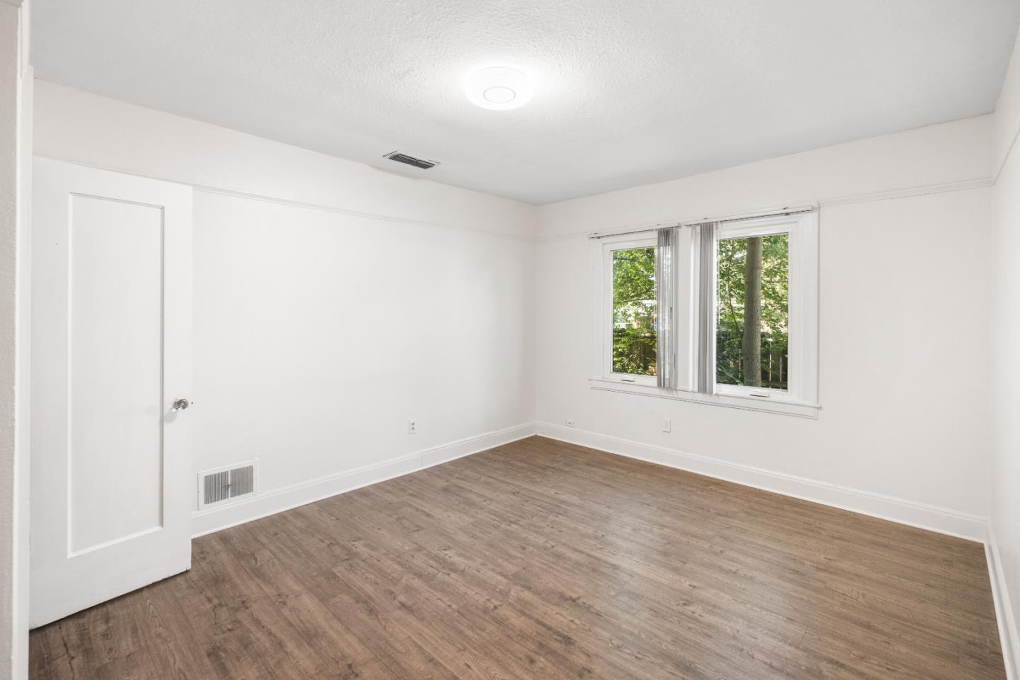 2905 Garfield Avenue Carmichael, CA 95608 - Photo 22 of 32 an empty room with wooden floor and windows