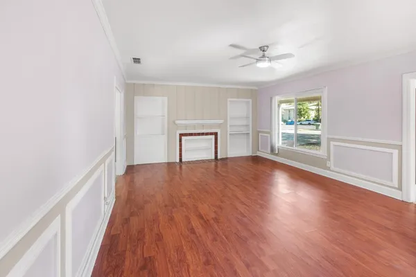 wooden floor in an empty room with a window