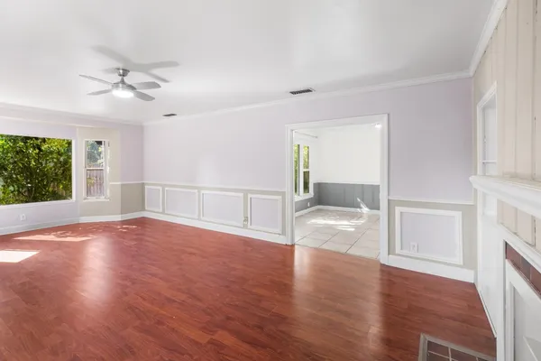 wooden floor in an empty room with a window
