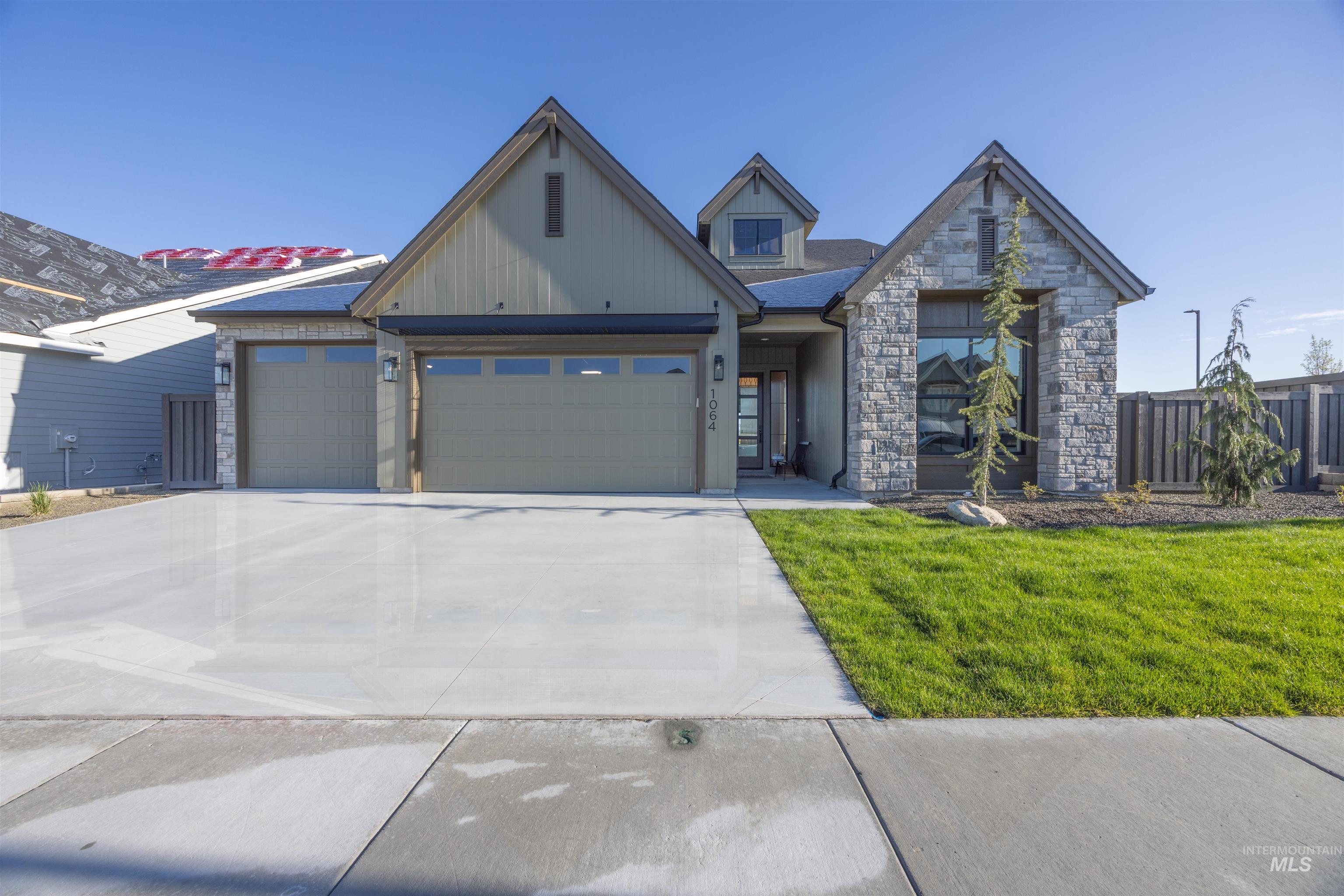 5847 South Pinpoint Way Meridian, ID 83642 - Photo 1 of 44 View of front of house with stone siding, an attached garage, and concrete driveway