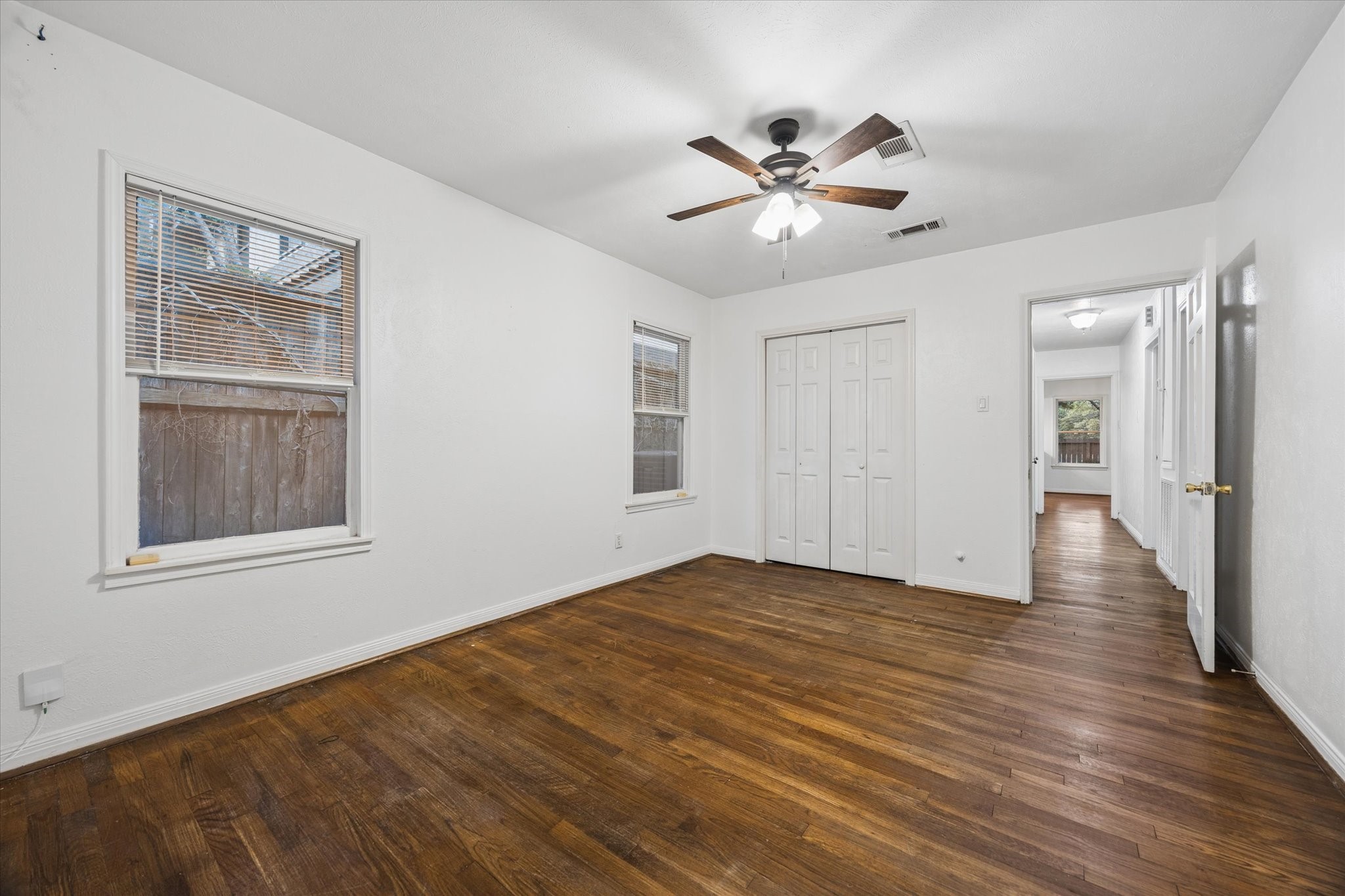 1931 Bissonnet Street Houston, TX 77005 - Photo 14 of 22 a view of an empty room with wooden floor and a window