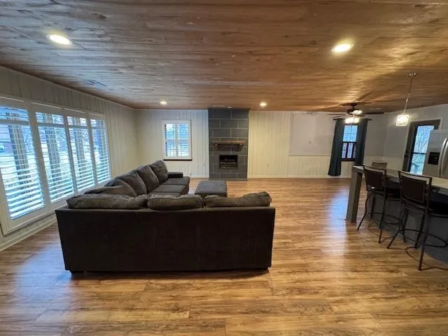a living room with furniture window and wooden floor