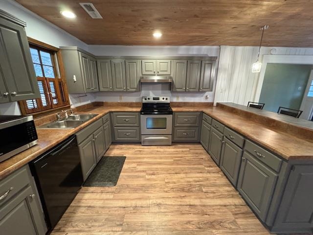 1519 Walters Street Covington, TN 38019 - Photo 6 of 15 a large kitchen with stainless steel appliances granite countertop a stove sink and cabinets