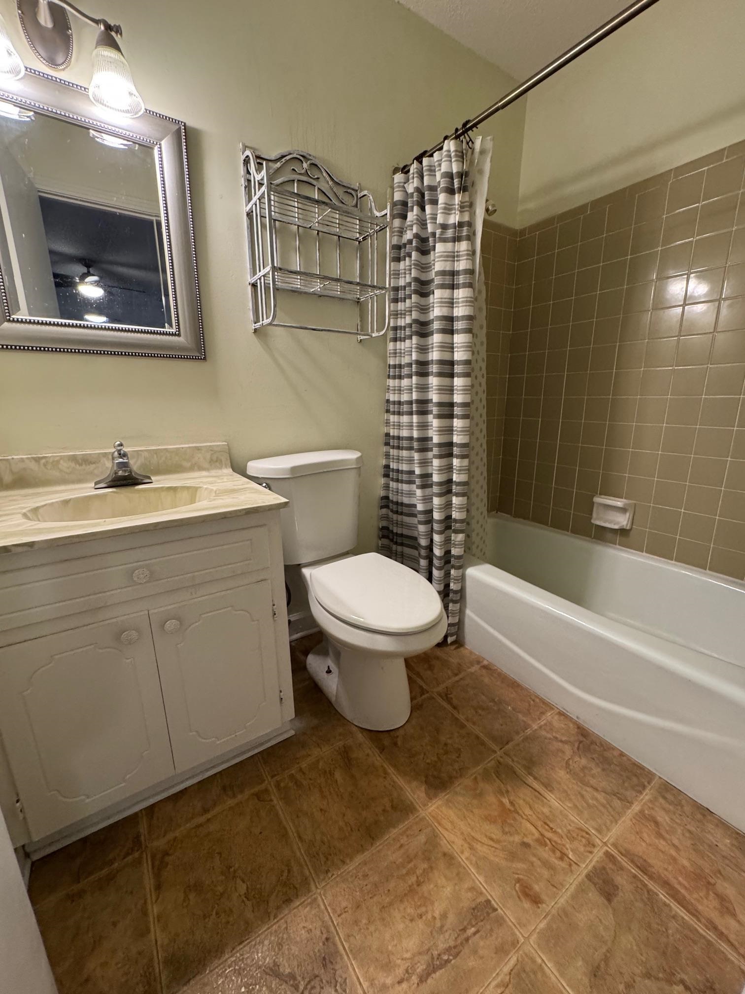 1519 Walters Street Covington, TN 38019 - Photo 8 of 15 a bathroom with a toilet a sink and bathtub
