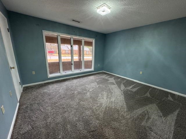 1519 Walters Street Covington, TN 38019 - Photo 10 of 15 an empty room with floor to ceiling windows and chandelier