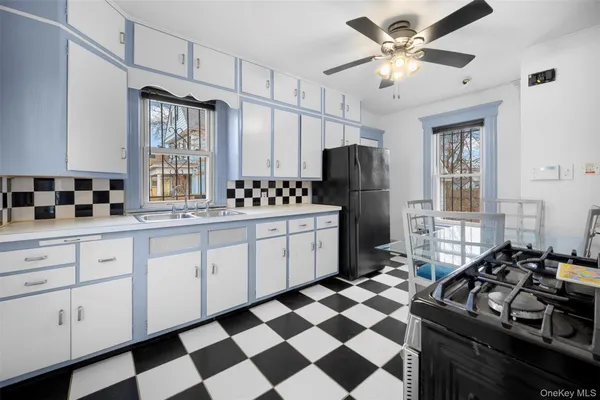 a kitchen with a stove a sink and a refrigerator
