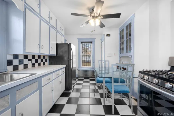 a kitchen with a sink a stove a refrigerator and cabinets
