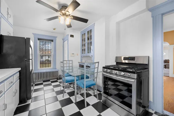 a kitchen with a stove a refrigerator and a fireplace