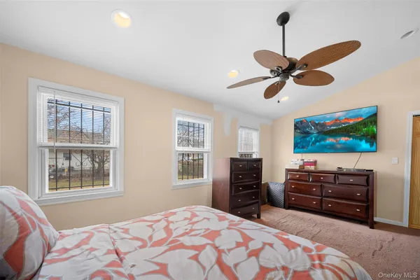 a bedroom with furniture and a flat screen tv