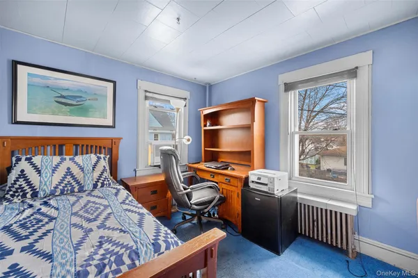 a bedroom with furniture and a window