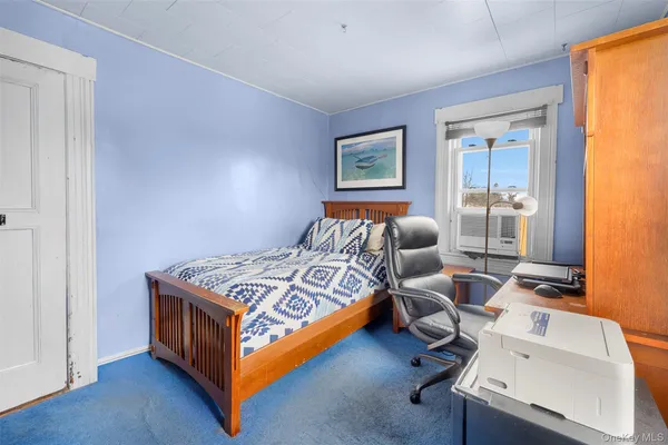 a bedroom with bed and a window
