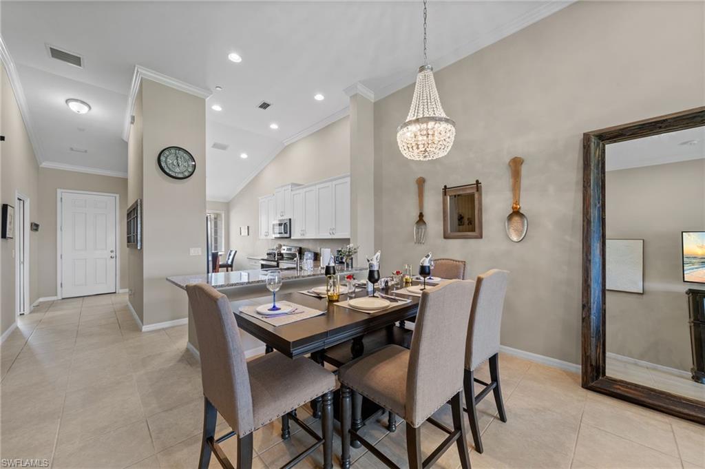 9366 Pocida Court, Unit 202 Naples, FL 34119 - Photo 13 of 44 a view of a dining room with furniture
