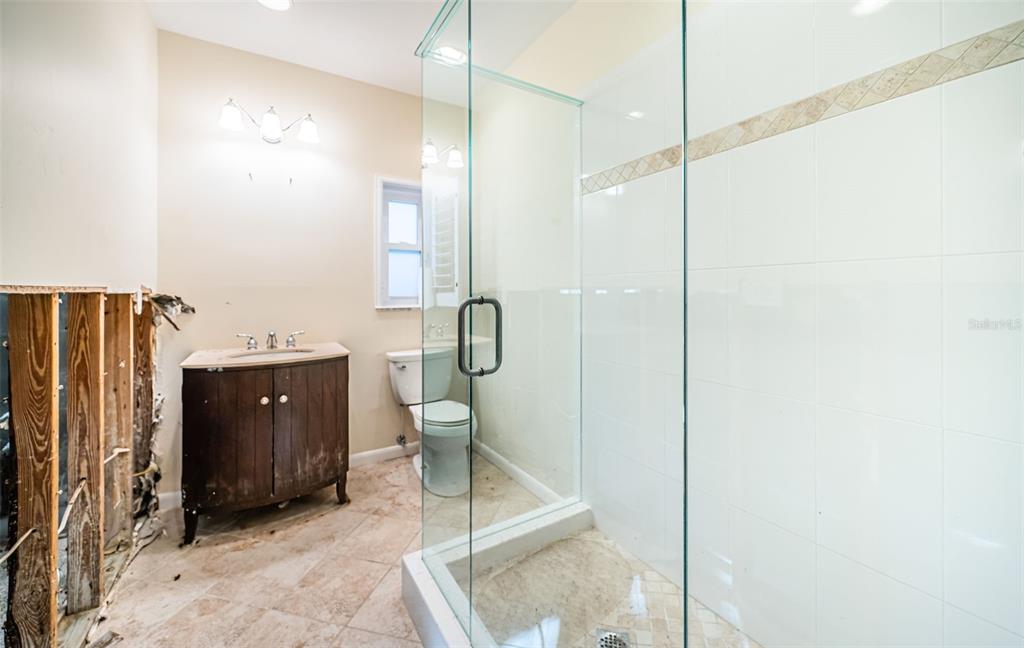 30 Dolphin Drive Treasure Island, FL 33706 - Photo 28 of 71 a bathroom with a toilet a sink and mirror