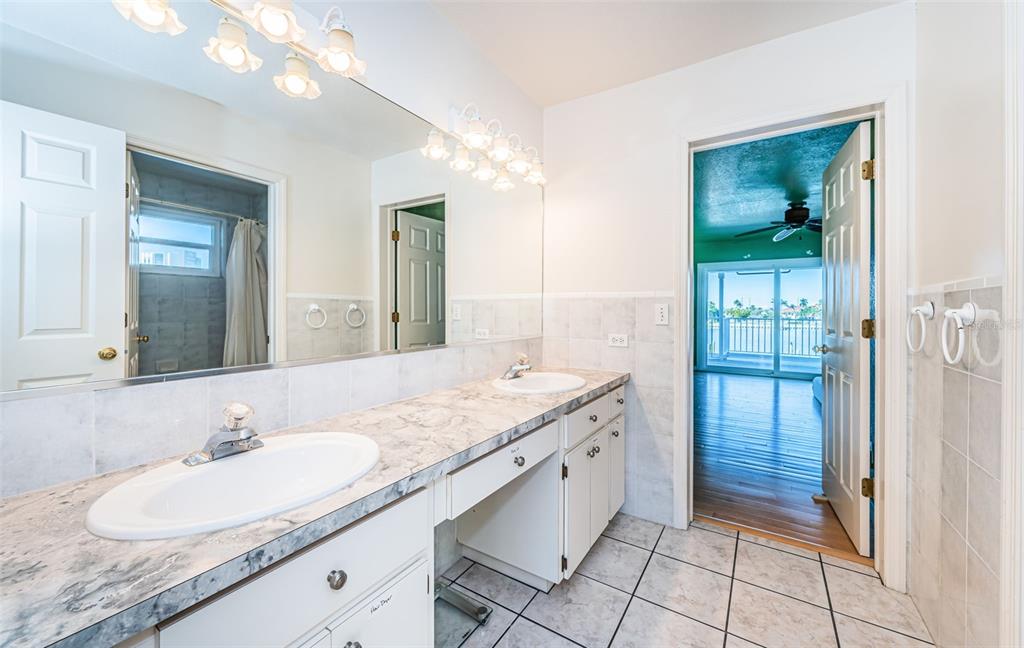 30 Dolphin Drive Treasure Island, FL 33706 - Photo 39 of 71 a bathroom with a granite countertop sink and a mirror
