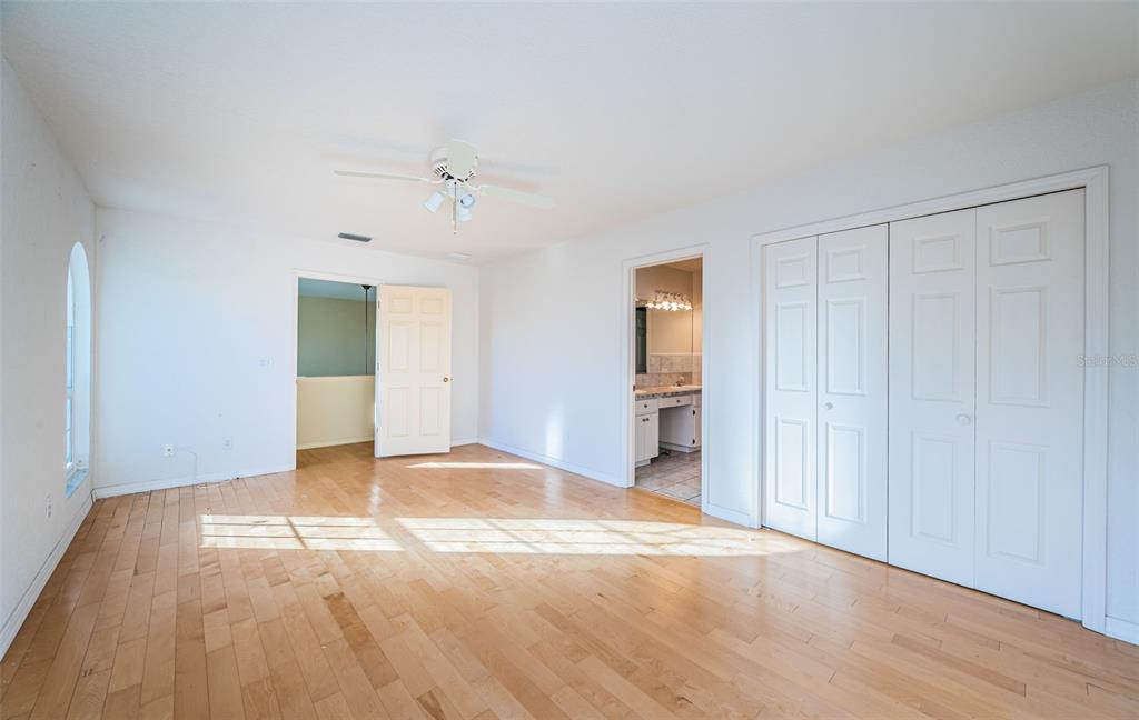 30 Dolphin Drive Treasure Island, FL 33706 - Photo 43 of 71 a view of empty room with wooden floor and ceiling fan