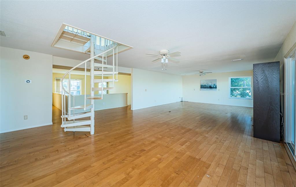 30 Dolphin Drive Treasure Island, FL 33706 - Photo 51 of 71 a view of empty room with wooden floor and fan