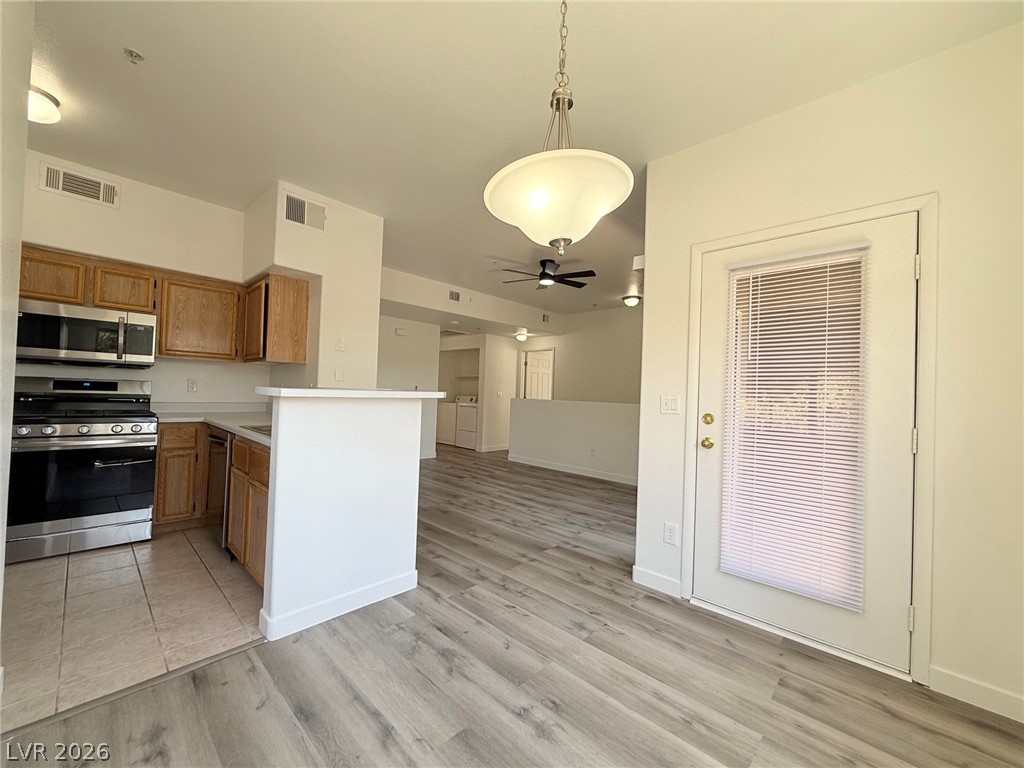 9050 West Warm Springs Road, Unit 2002 Las Vegas, NV 89148 - Photo 46 of 46 This inviting space features a modern kitchen and an open floorplan, perfect for comfortable living.