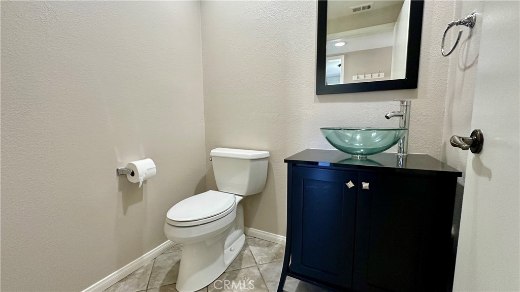 19526 Turtle Ridge Lane Porter Ranch, CA 91326 - Photo 11 of 27 a bathroom with a toilet sink and mirror