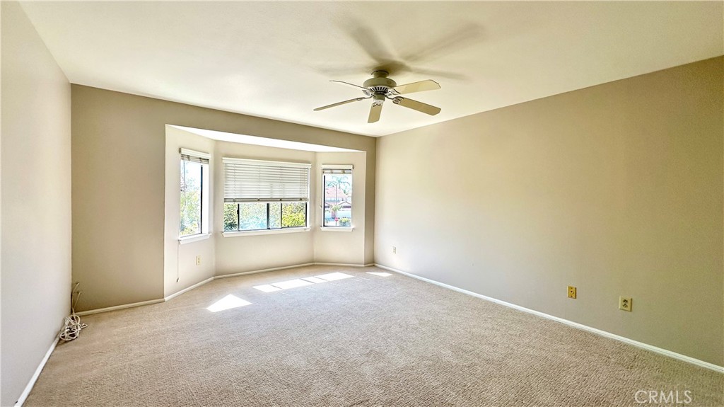 19526 Turtle Ridge Lane Porter Ranch, CA 91326 - Photo 12 of 27 an empty room with windows and ceiling fan