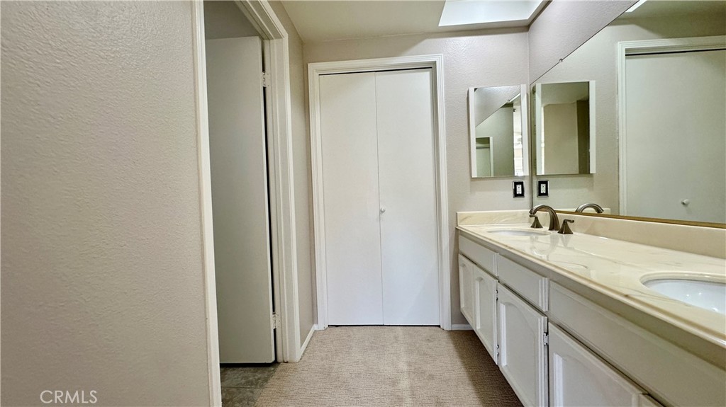 19526 Turtle Ridge Lane Porter Ranch, CA 91326 - Photo 14 of 27 a bathroom with 2 sink and a mirror