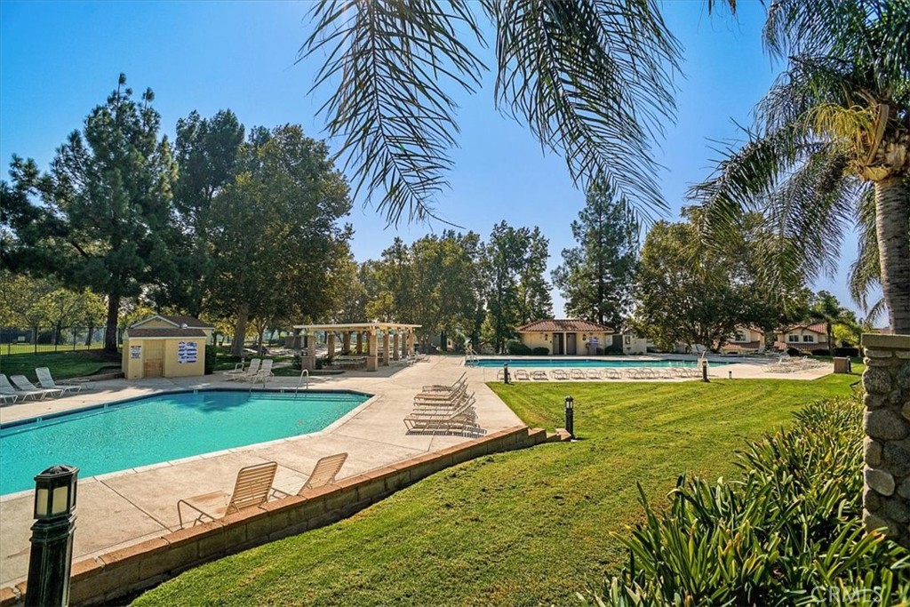 19526 Turtle Ridge Lane Porter Ranch, CA 91326 - Photo 25 of 27 a view of a swimming pool with a garden and trees