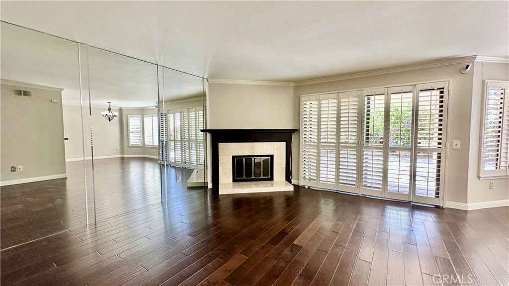 19526 Turtle Ridge Lane Porter Ranch, CA 91326 - Photo 3 of 27 an empty room with wooden floor fireplace and windows