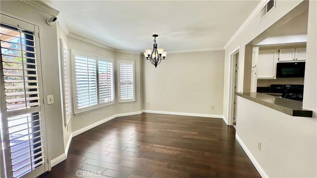 19526 Turtle Ridge Lane Porter Ranch, CA 91326 - Photo 7 of 27 a view of a kitchen with wooden floor and a ceiling fan
