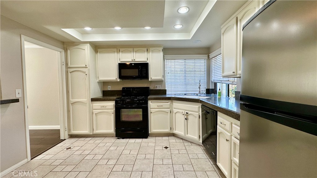 19526 Turtle Ridge Lane Porter Ranch, CA 91326 - Photo 9 of 27 a kitchen with stainless steel appliances a refrigerator sink and microwave
