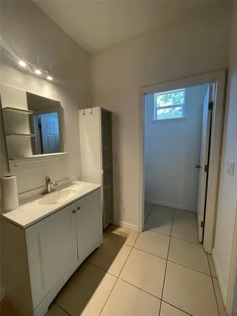 a bathroom with a sink a toilet and mirror
