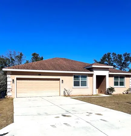 a front view of a house with a road