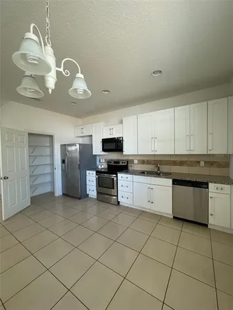 a kitchen with stainless steel appliances granite countertop a sink and cabinets