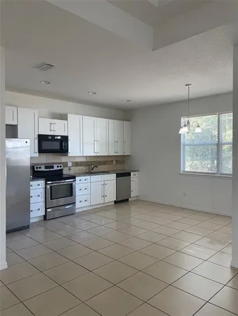 a large kitchen with cabinets and stainless steel appliances