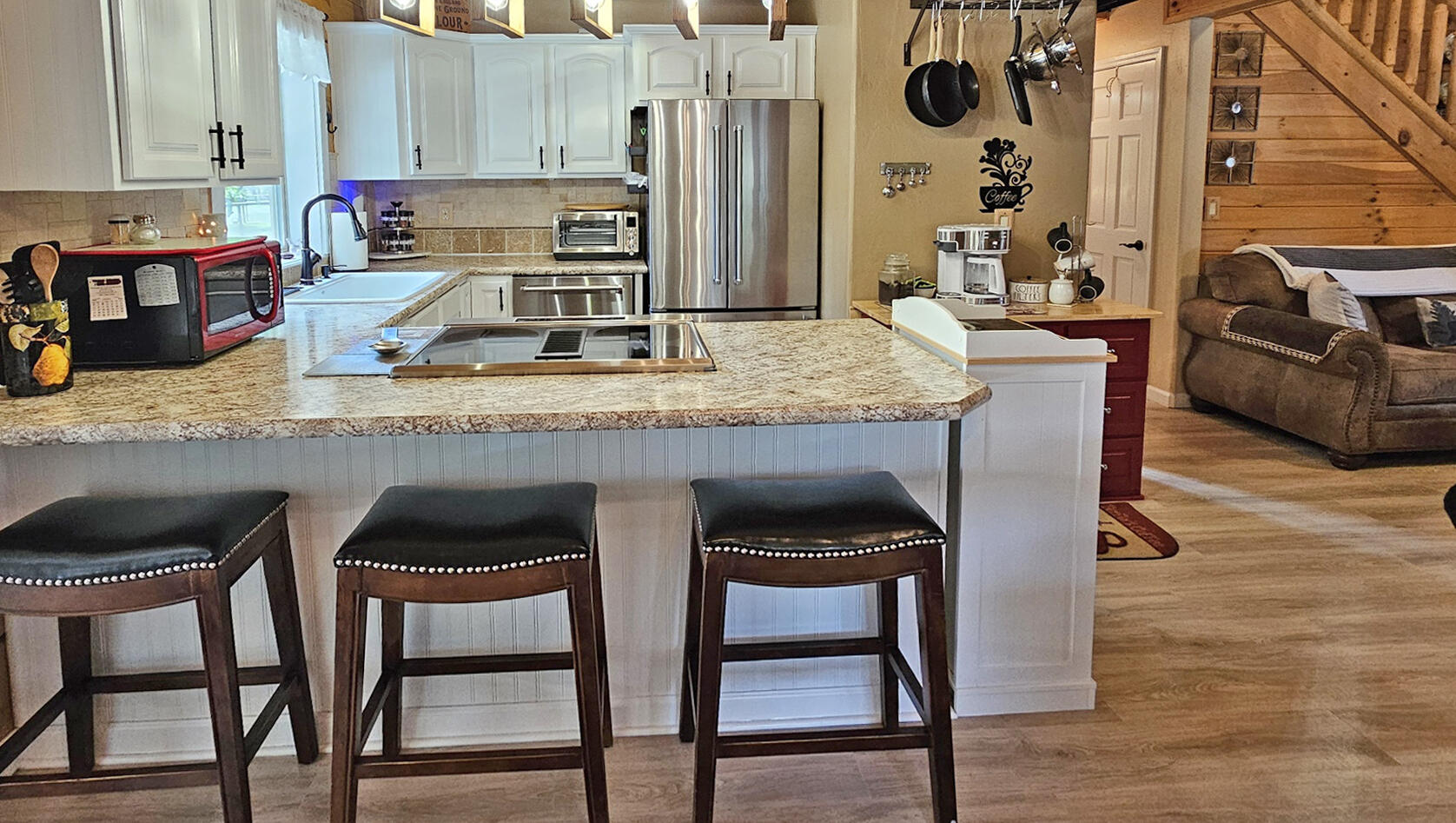 17659 Rosland Road La Pine, OR 97739 - Photo 12 of 33 a kitchen with granite countertop a sink and chairs