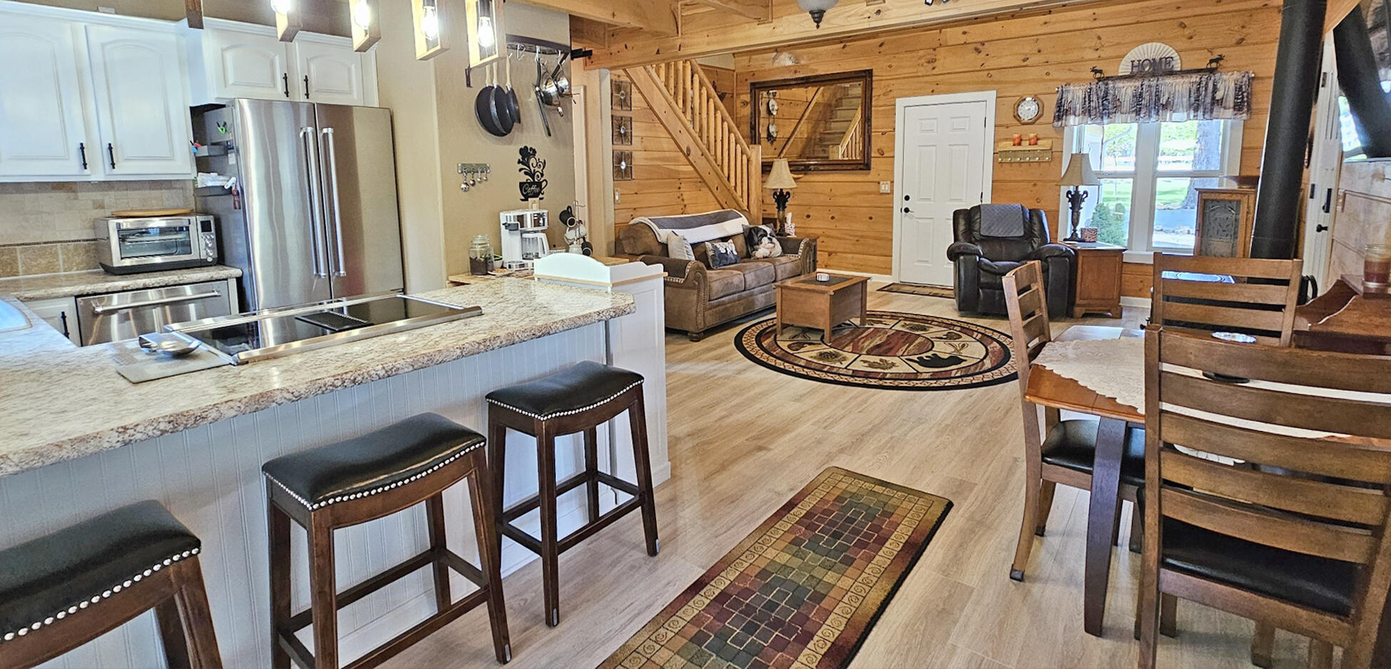17659 Rosland Road La Pine, OR 97739 - Photo 13 of 33 a kitchen with a table chairs stove and granite counter top