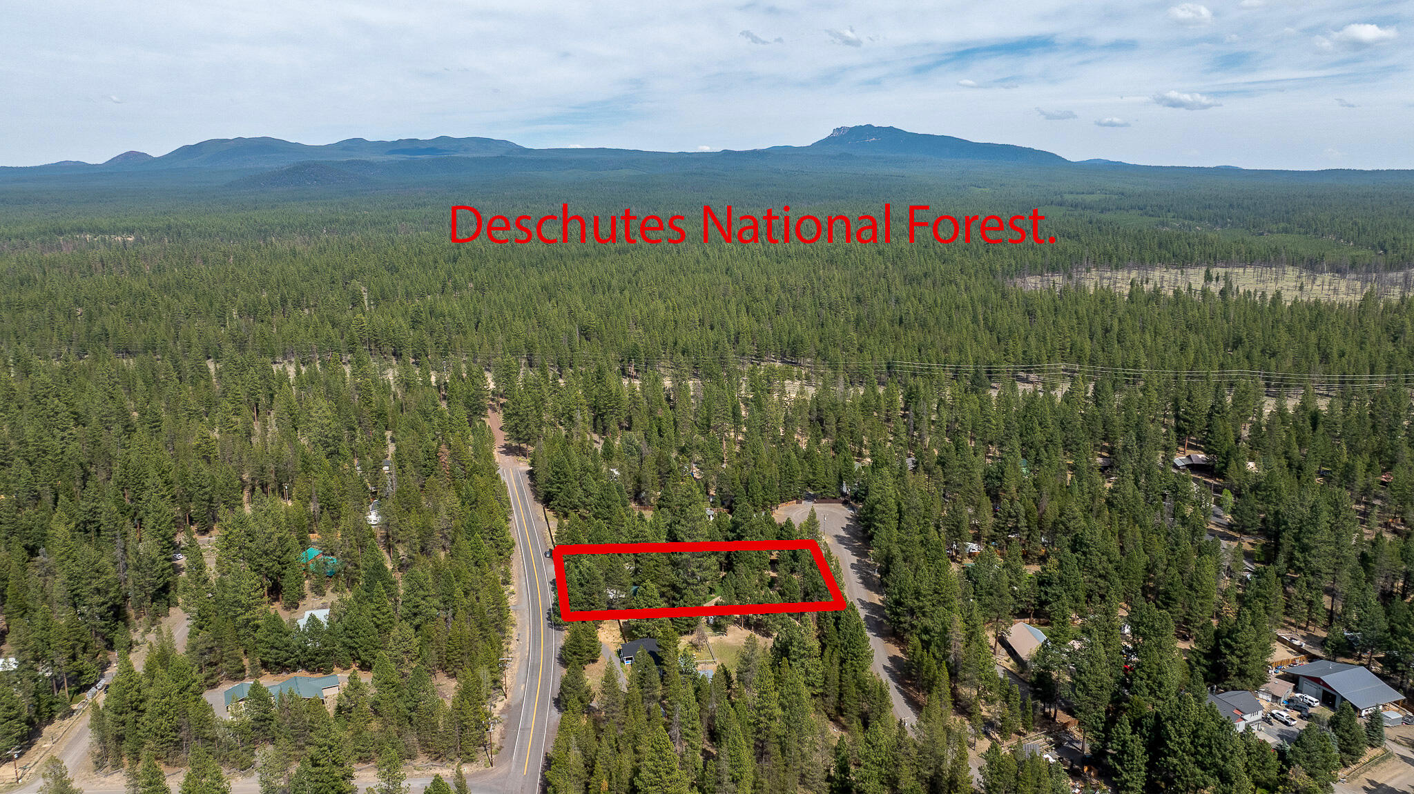 17659 Rosland Road La Pine, OR 97739 - Photo 26 of 33 a view of a lush green hillside and a houses