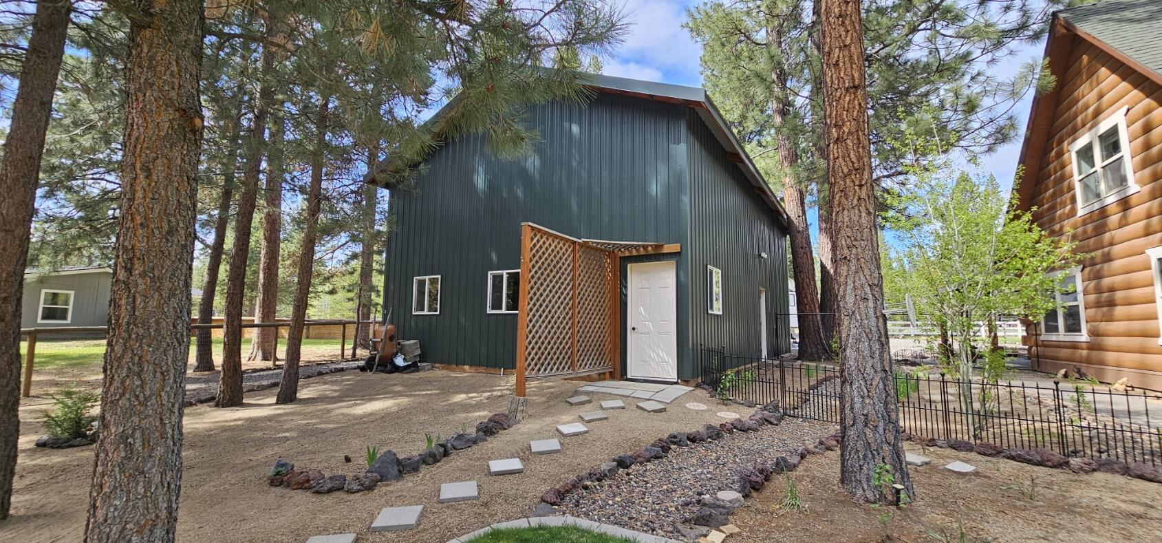 17659 Rosland Road La Pine, OR 97739 - Photo 6 of 33 a backyard of a house with large trees and wooden fence