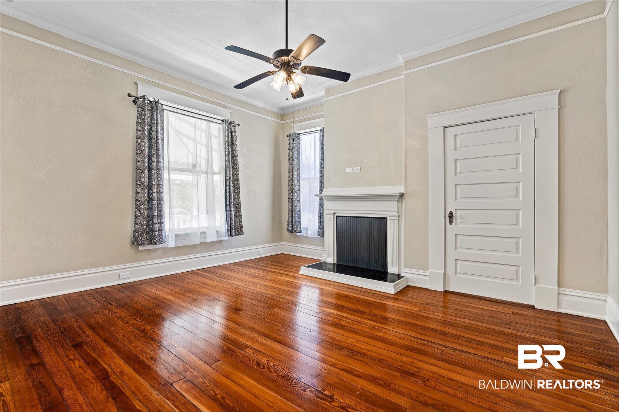 1310 Brown Street Mobile, AL 36604 - Photo 15 of 18 Unfurnished living room with ornamental molding, hardwood / wood-style floors, and ceiling fan