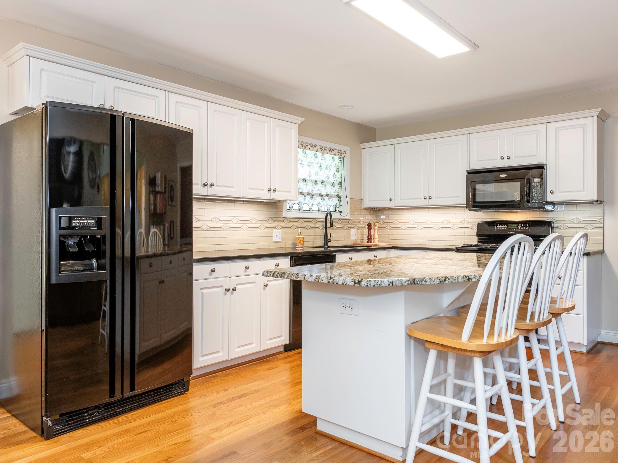 4440 Hucks Road Charlotte, NC 28269 - Photo 12 of 45 a kitchen with stainless steel appliances a refrigerator and a sink