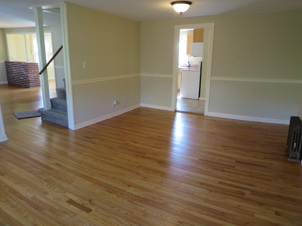 117 Stebbins Road Monson, MA 01057 - Photo 11 of 27 a view of a hallway with wooden floor and a bathroom
