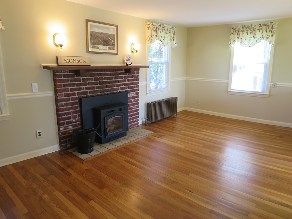 117 Stebbins Road Monson, MA 01057 - Photo 3 of 27 a view of empty room with wooden floor and fireplace