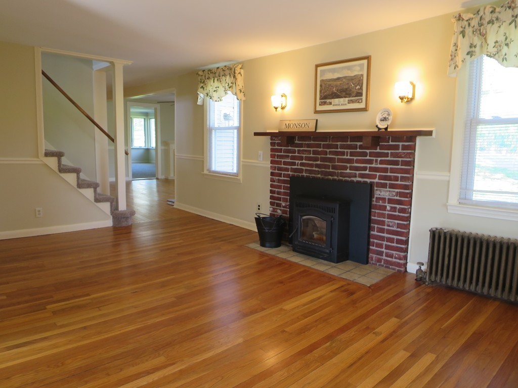 117 Stebbins Road Monson, MA 01057 - Photo 8 of 27 a view of an empty room with wooden floor fireplace and a window