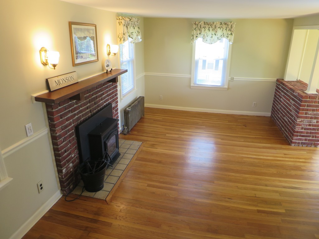 117 Stebbins Road Monson, MA 01057 - Photo 10 of 27 a view of a livingroom with wooden floor and a fireplace