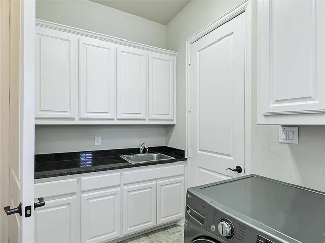 a kitchen with white cabinets and a stove