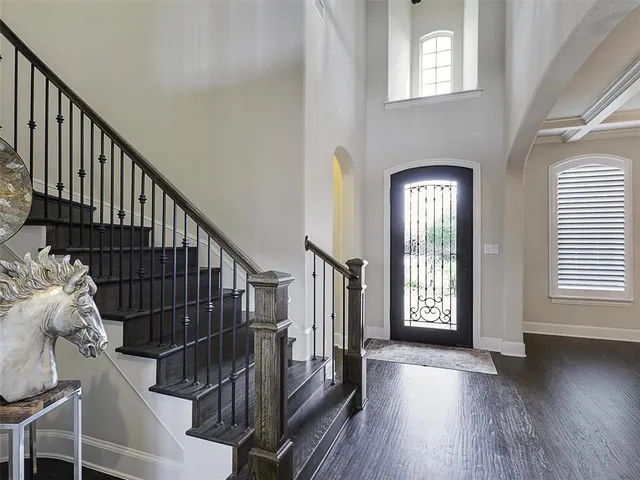 a view of entryway with wooden floor and stairs